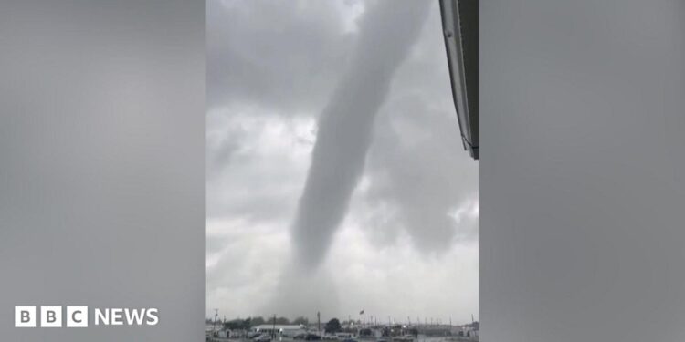 A tornado above a car park.