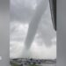 A tornado above a car park.