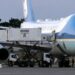 Step-by-step graphic showing how President Trump is reported to have switched planes at Ankara airport in July. Panel one shows Trump boarding the old Air Force One plane to leave Turkey on 8 July. Panel two shows Air Force One on the tarmac, with a catering truck raised to aircraft-door level on the far side and media boarding at the back of the plane. Panel three shows the catering truck driving from Air Force One to a nearby C‑32A military aircraft. Panel four shows Trump exiting Air Force One after reportedly reboarding the aircraft after it landed in the UK. Green circles and labels highlight the catering truck, media boarding point and C‑32A steps. Source: Washington Post, White House pool footage via Reuters.
