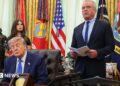 Donald Trump speaks from a lectern during a news conference at the White House. He is accompanied by Robert F Kennedy Jr.