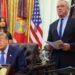 Donald Trump speaks from a lectern during a news conference at the White House. He is accompanied by Robert F Kennedy Jr.