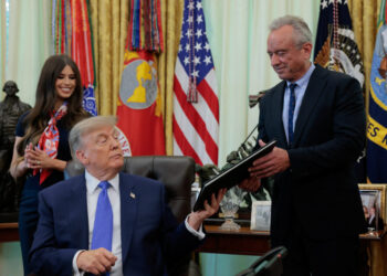 U.S. President Donald Trump signs an executive order in the Oval Office at the White House in Washington