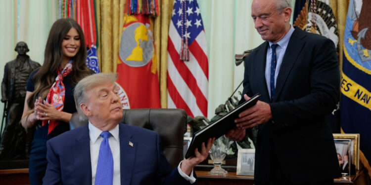 U.S. President Donald Trump signs an executive order in the Oval Office at the White House in Washington
