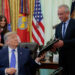 U.S. President Donald Trump signs an executive order in the Oval Office at the White House in Washington