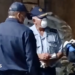 Three officers in face masks and uniform in discussion during a raid on a meth lab found at a farm in Limpopo province