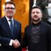 Burnham and Zelensky pose looking at the camera while shaking hands with soldiers behind them, on the steps of Horodetskyi House in Kyiv on Monday.