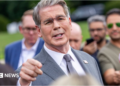 US Treasury Secretary Scott Bessent addresses members of the media on the lawn outside the White House. He's wearing a light grey suit, white shirt and silver tie