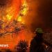 A member of the Spokane Valley Fire Department battles a fire northeast of Spokane, Washington