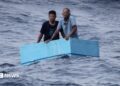 Two men inside a cooling box in the middle of the sea