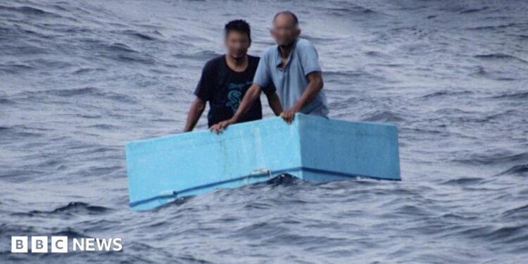 Two men inside a cooling box in the middle of the sea