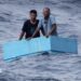 Two men inside a cooling box in the middle of the sea