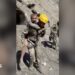 Two rescuers carry people on their backs