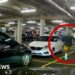 A man in blue sneakers is circled in red, running through a car park.