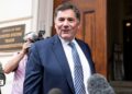 Dominic LeBlanc, in a suit and tie, speaks to reporters as he stands outside the doors to the US trade representative's office