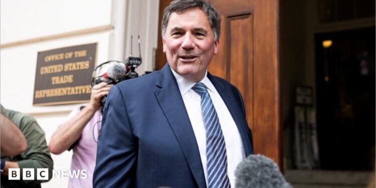Dominic LeBlanc, in a suit and tie, speaks to reporters as he stands outside the doors to the US trade representative's office