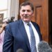 Dominic LeBlanc, in a suit and tie, speaks to reporters as he stands outside the doors to the US trade representative's office