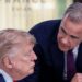 US President Donald Trump (left) speaks with Canada's Prime Minister Mark Carney during a work lunch as part of the G7 summit, in Evian, eastern France, on June 16, 2026. Trump is sitting down while Carney is standing over but leaning into the conversation.