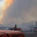 Firefighters respond beneath a massive smoke plume during the Spokane-area wildfires