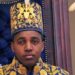 King Oyo pictured at 18 during his coronation wearing a gold embroidered jacket and hat.