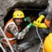 Nepalese rescuers wading through puddles of water in the Trishuli 3A tunnel
