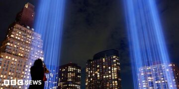 Fire Department of New York (FDNY) firefighters pay their respects at the memorial before a ceremony to commemorate the 25th anniversary of the September 11th terrorist attacks on the World Trade Center