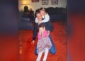 image shows girls posing with father