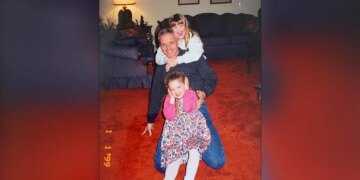 image shows girls posing with father