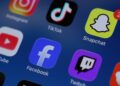Social media apps are displayed on a mobile phone