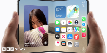 An image of the new foldable iPhone Duo in a woman's hands, being opened like a book.