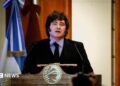 Argentine President speaks during a ceremony commemorating the 172nd anniversary of the Buenos Aires Stock Exchange in Buenos Aires, Argentina, July 16, 2026. He is wearing a dark suit with a black tie and a light blue shirt. He stands at a lectern and to his left there is an Argentine flag.