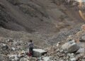 rescue personnel stands in rocky mountain landscape
