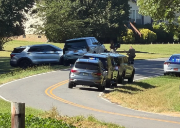 Police vehicles surround the scene of a deadly shooting on Forbes Road in Gaston County