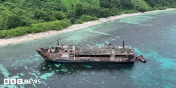 A handout photo made available by the Philippine Coast Guard shows an aerial view of a burnt ferry off Palawan province.