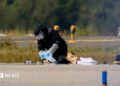 A blurred image of a man defusing a bomb on an airport runway