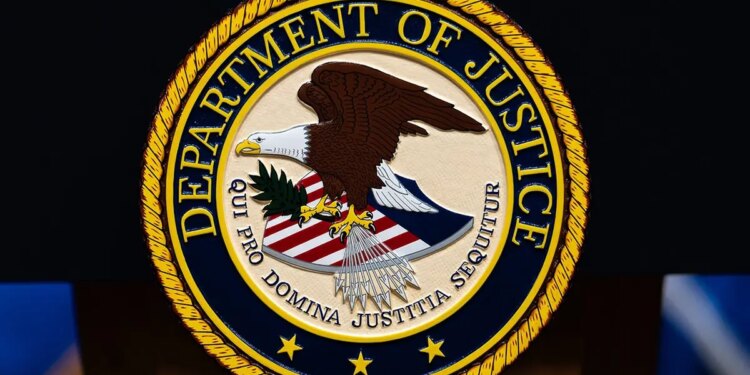 U.S. Department of Justice logo displayed on a podium.