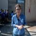Lucy Williamson in front of children in school uniform.