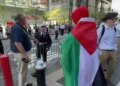 Firefighter confronting pro-Palestinian protester in Elmo costume