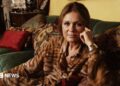 Gloria Steinem lying on a couch