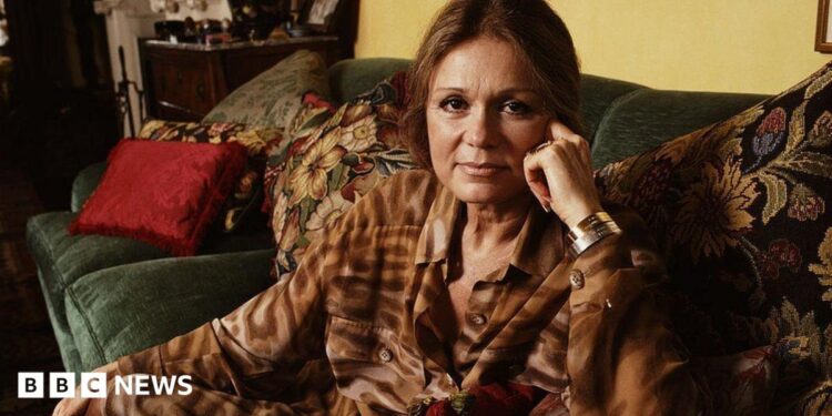 Gloria Steinem lying on a couch