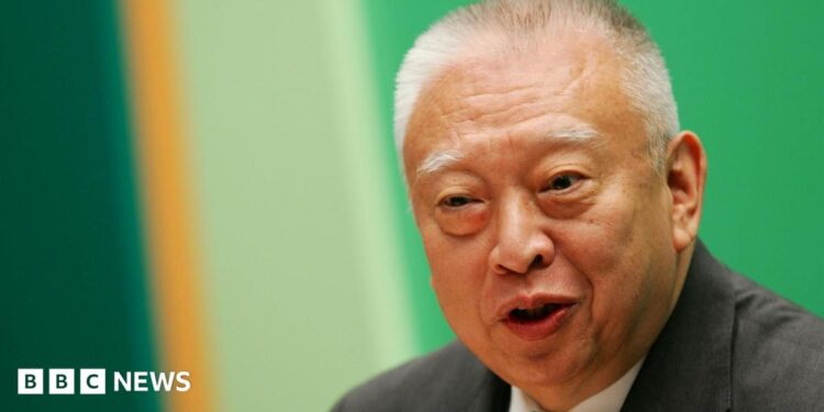 Tung Chee-hwa wearing a dark suit and white shirt