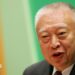Tung Chee-hwa wearing a dark suit and white shirt