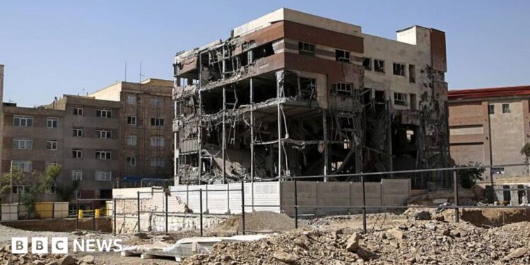 General view of a five-storey building in Tehran. The building has been shelled-out by a reported missile attack, the outer brickwork is no longer visible and instead the building is hollowed out but is still standing. It is surrounded by rubble