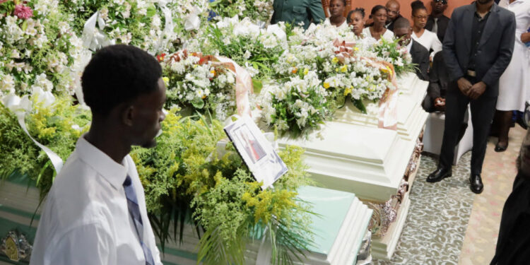 Relatives and residents attend the funeral of victims in Kenscoff