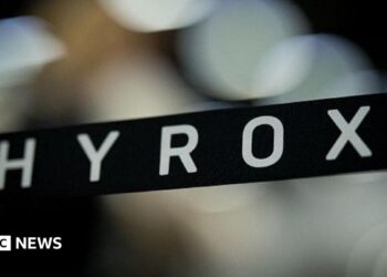 A stock image with a banner showing the name Hyrox over an out-of-focus background.