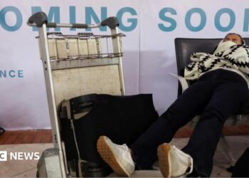 Stranded passengers rest as Soekarno Hatta International Airport closed its operations