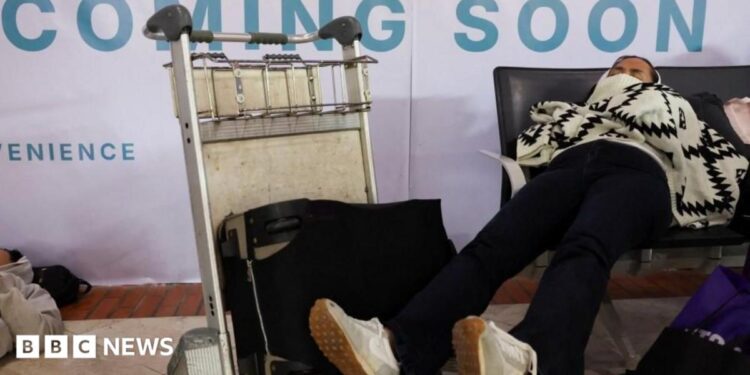 Stranded passengers rest as Soekarno Hatta International Airport closed its operations