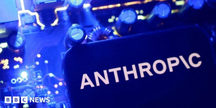 A smartphone display showing the Anthropic logo in black letters on an all-white background, laid on a laptop keyboard lit in pink and purple