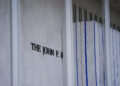 Tarp remains surrounding scaffolding after the removal of letters from the facade of the John F. Kennedy Memorial Center f...