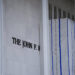 Tarp remains surrounding scaffolding after the removal of letters from the facade of the John F. Kennedy Memorial Center f...