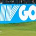 Golfer Bryson DeChambeau putts in front of a big blue and white LIV Golf sign